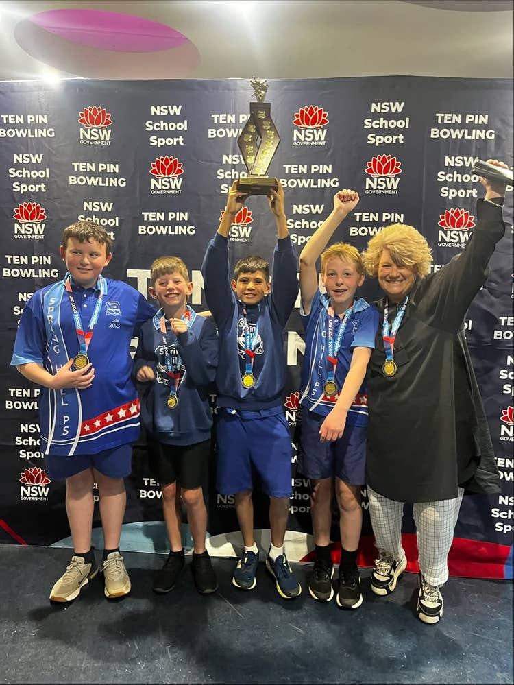For student success, there is a photo of four winning students and Mrs Mac standing next to them. There is a banner behind them saying NSW School Sport, Ten Pin Bowling. The students all have medals around their necks and the child in the middle of the photo is holding a large trophy above his head.